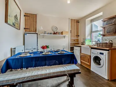 a kitchen with a table with a blue table cloth at 3 Bed in Ullock SZ043 in Arlecdon