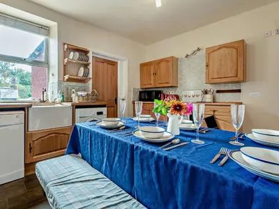 a kitchen with a table with a blue table cloth at 3 Bed in Ullock SZ043 in Arlecdon