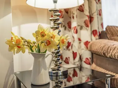 a vase with flowers on a table in a living room at 2 bed in Keswick SZ062 in Keswick