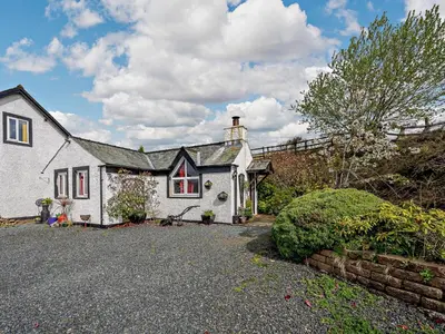 a white house with a driveway in front of it at 1 Bed in Troutbeck SZ254 in Troutbeck