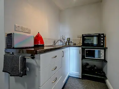 a kitchen with a sink and a microwave at 1 Bed in Troutbeck SZ254 in Troutbeck