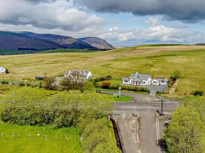 an aerial view of a house in the middle of a field at 1 Bed in Troutbeck SZ254 in Troutbeck
