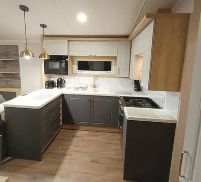 a kitchen with a sink and a stove at Hillingworth's Hot Tub Retreat - Lochmaben in Dumfries