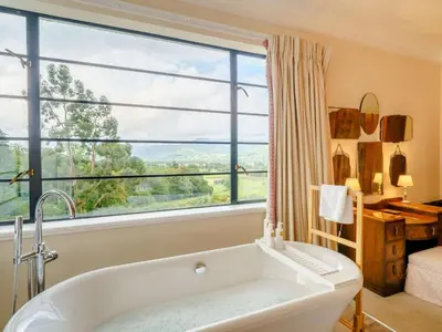 a bath tub in a bathroom with a large window at 6 Bed in Keswick oc-89309 in Applethwaite