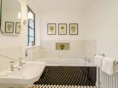 a white bathroom with a tub and a sink at 6 Bed in Keswick oc-89309 in Applethwaite