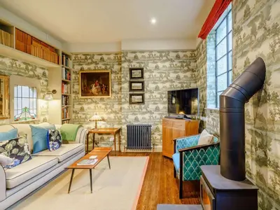 a living room with a couch and a fireplace at 6 Bed in Keswick oc-89309 in Applethwaite