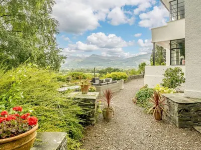 a garden with flowers and plants on a building at 6 Bed in Keswick oc-89309 in Applethwaite