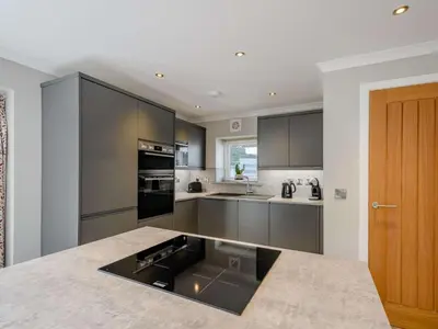 a kitchen with gray cabinets and a counter top at 1 Bed in Sandyhills 85904 in Fairgirth