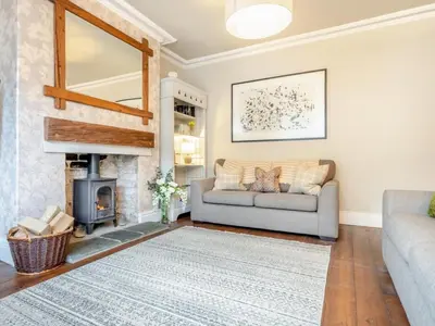 a living room with a couch and a fireplace at 3 Bed in Keswick oc-89526 in Keswick