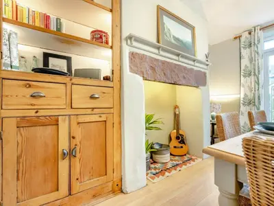 a kitchen with a large wooden cabinet and a guitar at 3 Bed in Keswick oc-89526 in Keswick