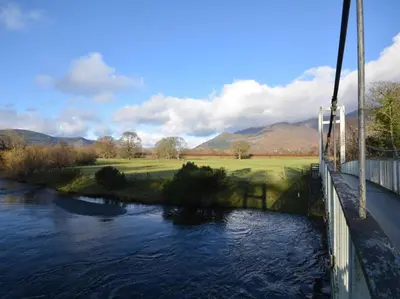 a bridge over a river with a golf course at 1 Bed in Keswick oc-82550 in Keswick