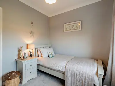 a bedroom with a bed and a nightstand with a lamp at 3 Bed in Cockermouth 82438 in Dearham