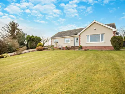 a house with a large grassy yard at 3 Bed in Cockermouth 82438 in Dearham