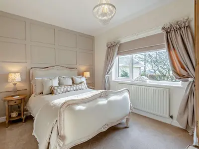 a bedroom with a white bed and a window at 3 Bed in Cockermouth 82438 in Dearham