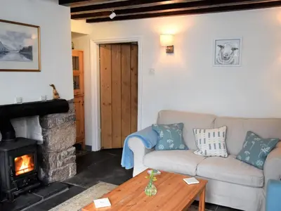 a living room with a couch and a fireplace at 3 Bed in Holmrook oc-sz313 in Boot