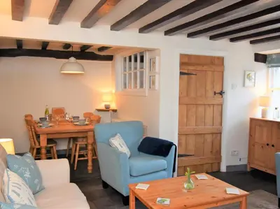 a living room with a table and a blue chair at 3 Bed in Holmrook oc-sz313 in Boot