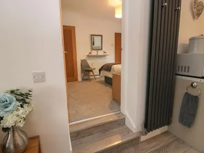 a hallway with a door leading to a bedroom at Hollys Hideaway in Castle Douglas