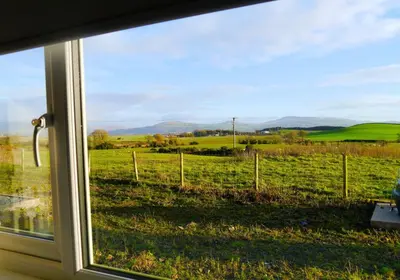 a view of a field from a window at Craigielea Cottage in Newton Stewart