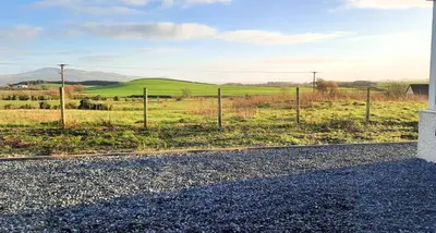a view of a field with a fence at Craigielea Cottage in Newton Stewart