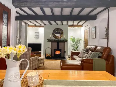 a living room with a couch and a fireplace at Daffodil Cottage in Cockermouth