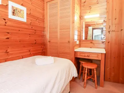 a bedroom with a bed and a vanity and a sink at Latrigg Lodge in Keswick