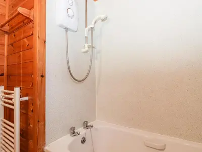 a bathroom with a white tub and a shower at Latrigg Lodge in Keswick