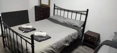 a bedroom with a bed with two towels on it at A Whole Terrace house to you in Distington