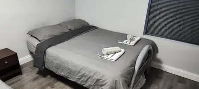 a bedroom with a bed with towels on it at A Whole Terrace house to you in Distington
