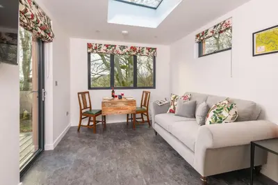 a living room with a couch and a table at Crocus Penruddock, dog & eco friendly lodge with hot tub in Penruddock