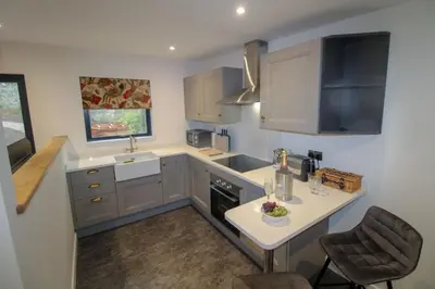 a small kitchen with a sink and a counter top at Shepherds Retreat Hutton John in a walled garden in a rural setting only 10 minutes for Lake Ullswater in Penruddock