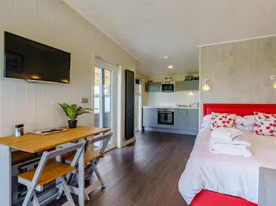 a bedroom with a bed and a desk and a kitchen at 1 Bed in Turnberry 78071 in Girvan