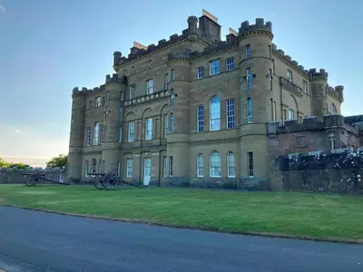 a large building with grass in front of it at 1 Bed in Turnberry 78071 in Girvan
