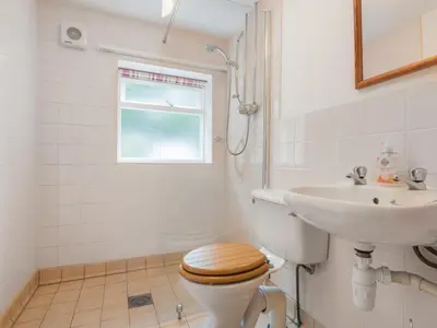 a bathroom with a toilet and a sink at 2 Bed in Caldbeck SZ212 in Caldbeck