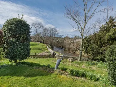 a view of a park with a river and trees at 2 Bed in Caldbeck SZ212 in Caldbeck