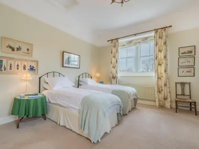 two beds in a bedroom with a window at 2 Bed in Caldbeck SZ212 in Caldbeck