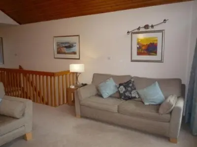 a living room with a couch and a chair at Keswick Bridge 20, within walking distance of Keswick town centre, strictly no pets in Keswick