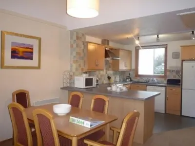 a kitchen with a table and a table and chairs at Keswick Bridge 20, within walking distance of Keswick town centre, strictly no pets in Keswick