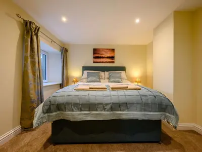 a bedroom with a large bed and a window at 3 Bed in Keswick 86867 in Keswick