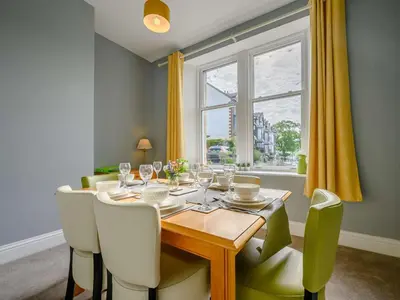 a dining room with a table and a window at 3 Bed in Keswick 86867 in Keswick