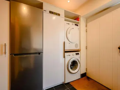 a kitchen with a refrigerator and a washer and dryer at 4 Bed in Keswick oc-89258 in Keswick