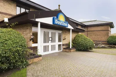 a day inn sign on the front of a building at Days Inn Hotel Abington - Glasgow in Abington