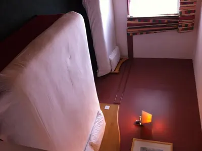 a bed in a room with a light on the floor at Days Inn Hotel Abington - Glasgow in Abington