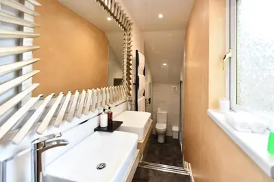 a bathroom with a sink and a mirror at The Townhouse Ayr - Luxury B&B - adults only in Ayr