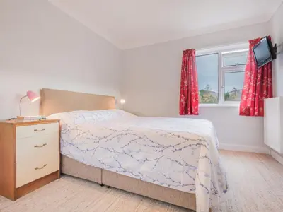 a bedroom with a bed with a dresser and a window at 2 Bed in Portinscale SZ071 in Portinscale