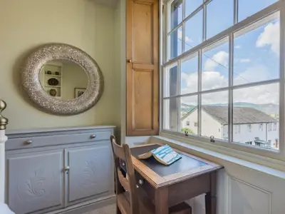 a room with a table and a mirror and a window at 2 Bed in Keswick oc-sz126 in Keswick