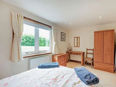 a bedroom with a bed and a window and a desk at 1 Bed in Balmaclellan CA371 in Castle Douglas