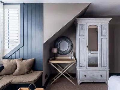 a bedroom with a bed and a dressing table with a mirror at 3 Bed in Portpatrick 77308 in Portpatrick