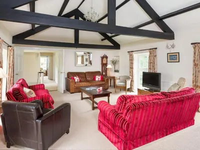 a living room with two red couches and a tv at 6 Bed in Workington oc-sz151 in Lamplugh