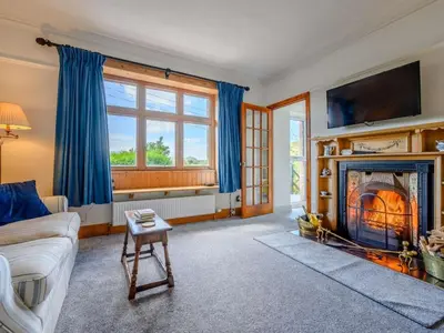 a living room with a couch and a fireplace at 3 Bed in Eskdale SZ072 in Santon Bridge