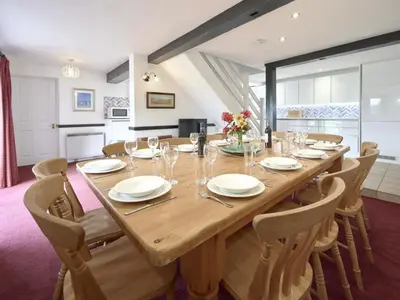 a large wooden table in a room with chairs at 8 Bed in Applethwaite SZ373 in Applethwaite